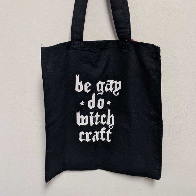 Black tote bag by Midge Blitz reads: be gay do witchcraft in white text  available at Coyote Supply Co, a zero waste witch store in Midtown Reno, Nevada that is BIPOC owned