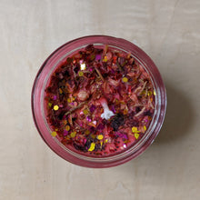 Load image into Gallery viewer, Red soy wax candle dressed with rose petals, poppy seeds, rosemary, &amp; glitter.  Made by Firme Arte &amp; sold by zero waste witch store Coyote Supply Co in Reno, Nevada.