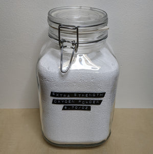 Large glass jar with metal hinge filled with oxygen laundry powder by Mama Suds available at Coyote Supply Co, a zero waste witch store in Midtown Reno, Nevada that is BIPOC owned