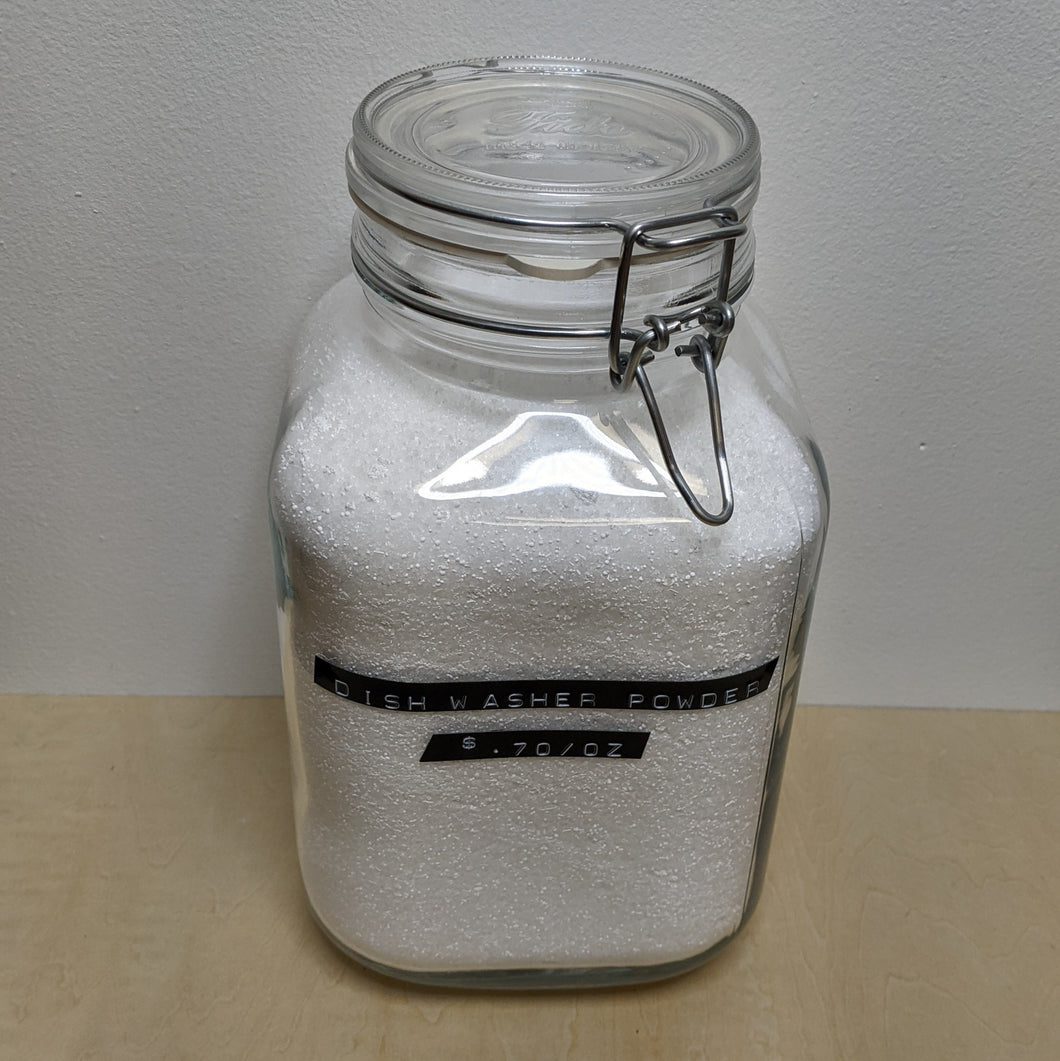 Large glass jar with metal hinge filled with dish washer powder by Mama Suds available at Coyote Supply Co, a zero waste witch store in Midtown Reno, Nevada that is BIPOC owned