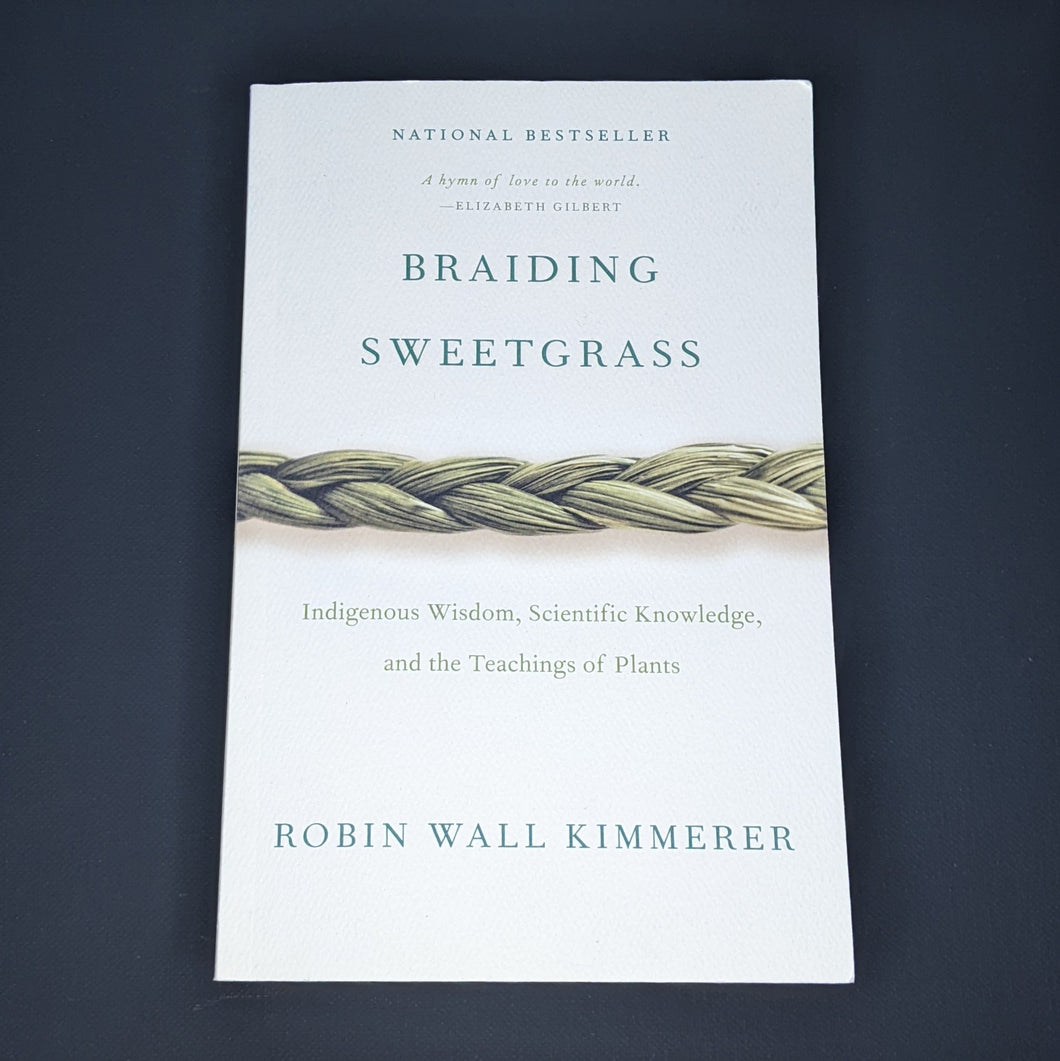 White book by Robin Wall Kimmerer features a photo of a sweetgrass braid and reads 