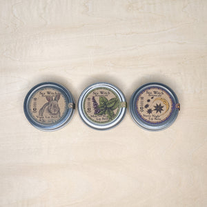 Three round tins containing vegan lip balm by Sea Witch Botanicals available at Coyote Supply Co, a zero waste witch store in Midtown Reno, Nevada that is BIPOC owned