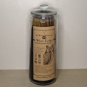 Glass jar filled with White Lodge incense by Sea Witch Botanicals. Kraft paper label features a black illustration of an owl available at Coyote Supply Co, a zero waste witch store in Midtown Reno, Nevada that is BIPOC owned 