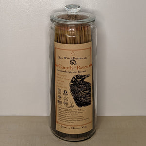 Glass jar filled with Quoth the Raven incense by Sea Witch Botanicals. Kraft paper label features a black illustration of a raven available at Coyote Supply Co, a zero waste witch store in Midtown Reno, Nevada that is BIPOC owned