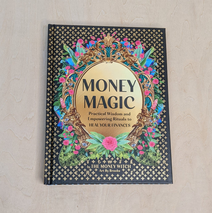 Black book cover of Money Magic by Jessie Susannah Karnatz, the Money Witch. Cover features a gold frame with the title inside it and colorful pink a blue flowers surrounding it available at Coyote Supply Co, a zero waste witch store in Midtown Reno, Nevada that is BIPOC owned