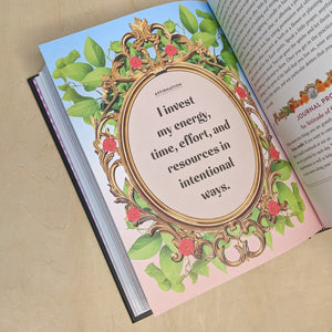 Page from Money Magic by Jessie Susannah Karnatz. Page features a blue to pink gradient background with a gold frame resting over green leaves. Inside of the frame reads "I invest my energy, time, effort, and resources in intentional ways" in black block lettering.