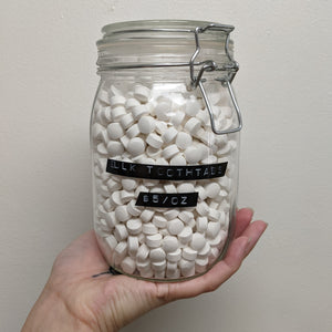 A large jar of Huppy Watermelon Strawberry tooth tabs toothpaste. Sold at Coyote Supply Co a BIPOC and LGBTQIA+ owned zero waste witch store in Reno Nevada 