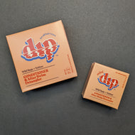 Dip Wild Sage + Vetiver Conditioner in an orange box in regular 4oz and .75oz travel sizes. Sold at Coyote Supply Co a BIPOC and LGBTQIA+ owned zero waste witch store in Reno Nevada