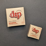 Dip Tobacco + Driftwood Shampoo in a light brown box in regular 4oz and .75oz travel sizes. Sold at Coyote Supply Co a BIPOC and LGBTQIA+ owned zero waste witch store in Reno Nevada