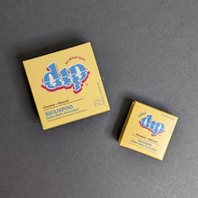 Load image into Gallery viewer, Dip Coconut + Almond Shampoo in a yellow box in regular 4oz and .75oz travel sizes. Sold at Coyote Supply Co a BIPOC and LGBTQIA+ owned zero waste witch store in Reno Nevada