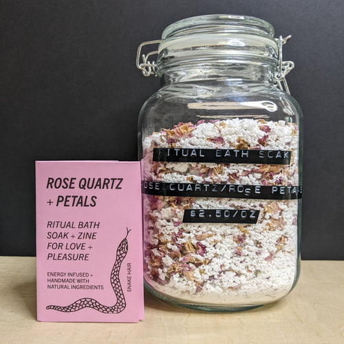 A glass mason jar of white bath soak with a black label that reads: 
