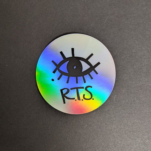 A circuar sticker with a holographic silver finish with a black eye and R.T.S. Sold at Coyote Supply Co a BIPOC and LGBTQIA+ owned zero waste witch store in Reno Nevada