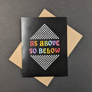 A black greeting card with rainbow text that reads As Above So Below. Sold at Coyote Supply Co a BIPOC and LGBTQIA+ owned zero waste witch store in Reno Nevada 