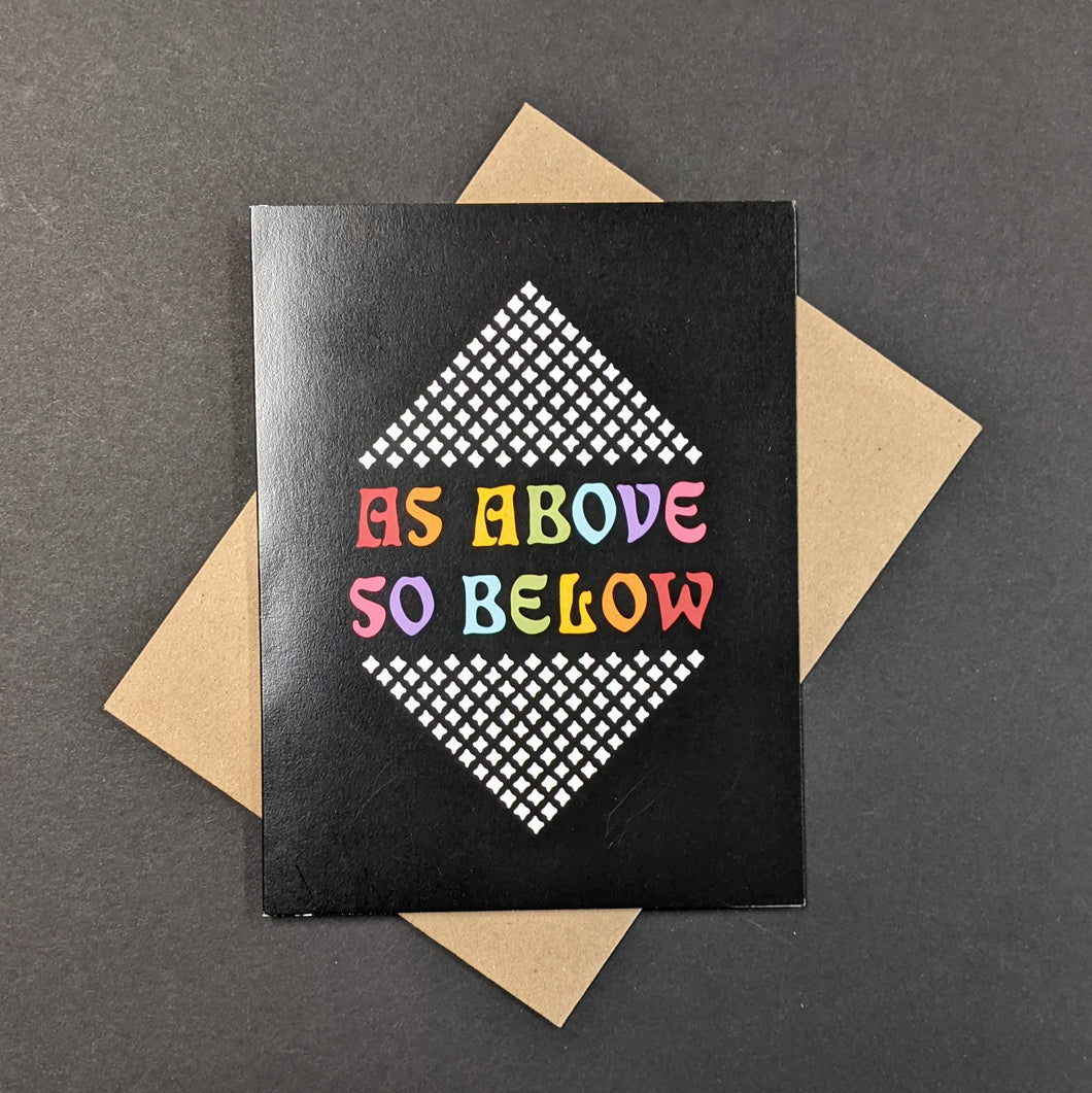 A black greeting card with rainbow text that reads As Above So Below. Sold at Coyote Supply Co a BIPOC and LGBTQIA+ owned zero waste witch store in Reno Nevada 